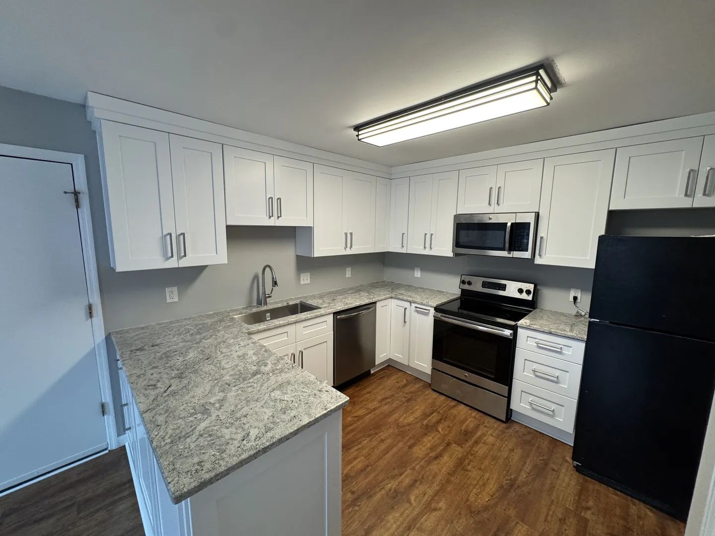 Kitchen after renovation - Hunters Branch, Antioch - white shaker cabinets with granite countertops